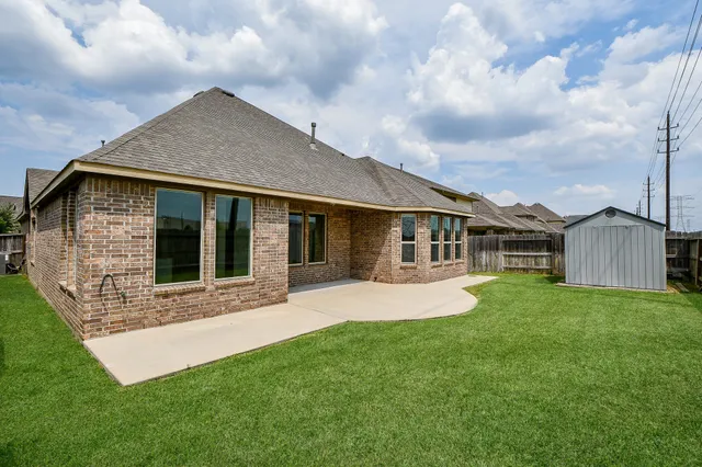 a front view of a house with a garden and yard