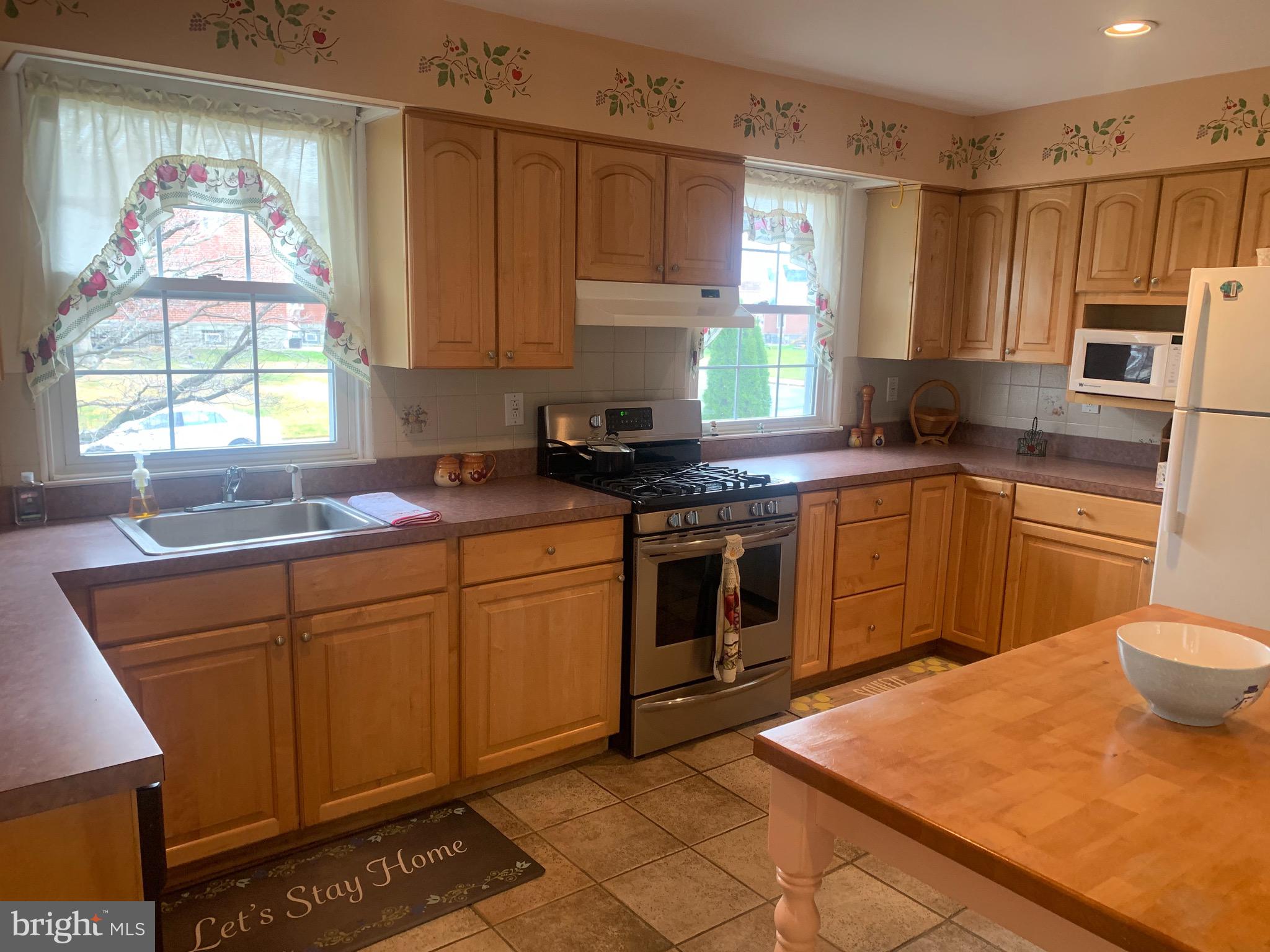 9902 Medway Road Philadelphia, PA 19115 - Photo 2 of 28 a kitchen with stainless steel appliances granite countertop a sink stove and refrigerator