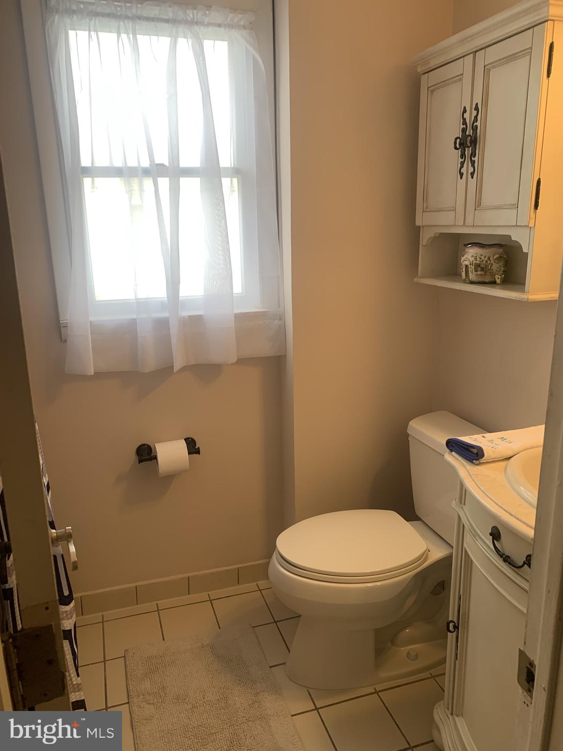 9902 Medway Road Philadelphia, PA 19115 - Photo 13 of 28 a white toilet sitting next to a window in a bathroom