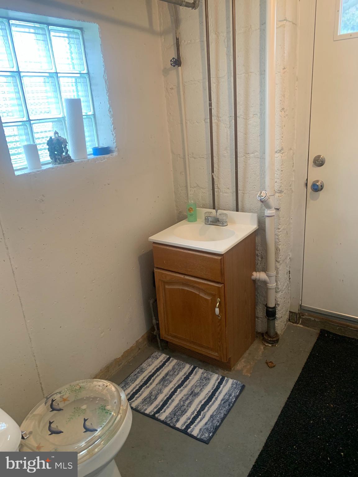 9902 Medway Road Philadelphia, PA 19115 - Photo 24 of 28 a bathroom with a sink toilet and window