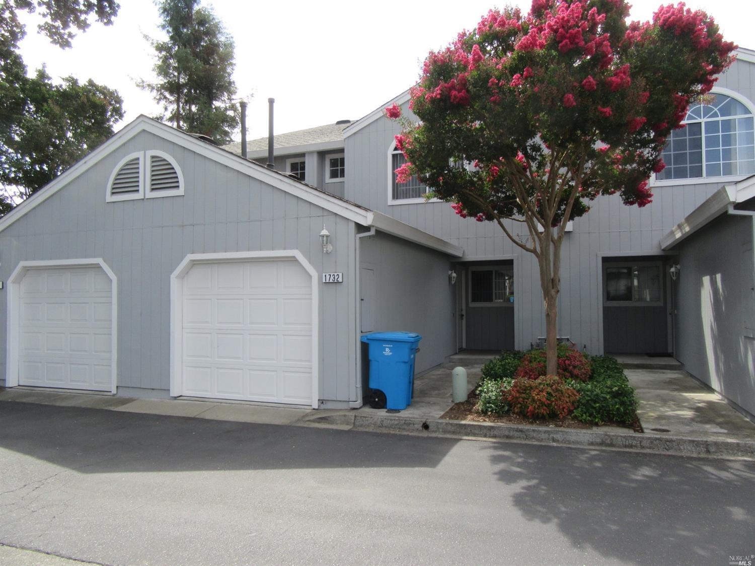 a front view of a house with garage