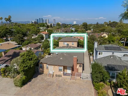 an aerial view of a house with a yard basket ball court and outdoor seating