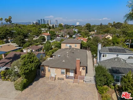 an aerial view of multiple houses with a yard