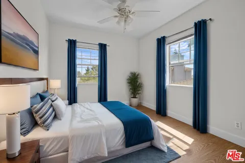 a bedroom with a bed and a large mirror