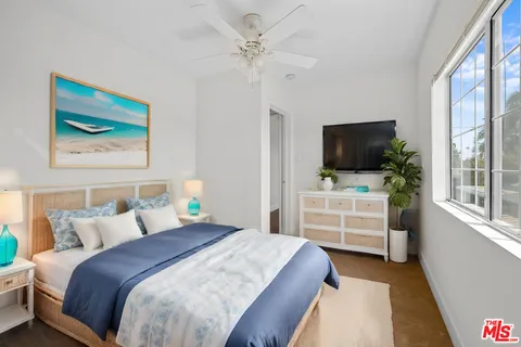 a bedroom with a bed and a flat screen tv
