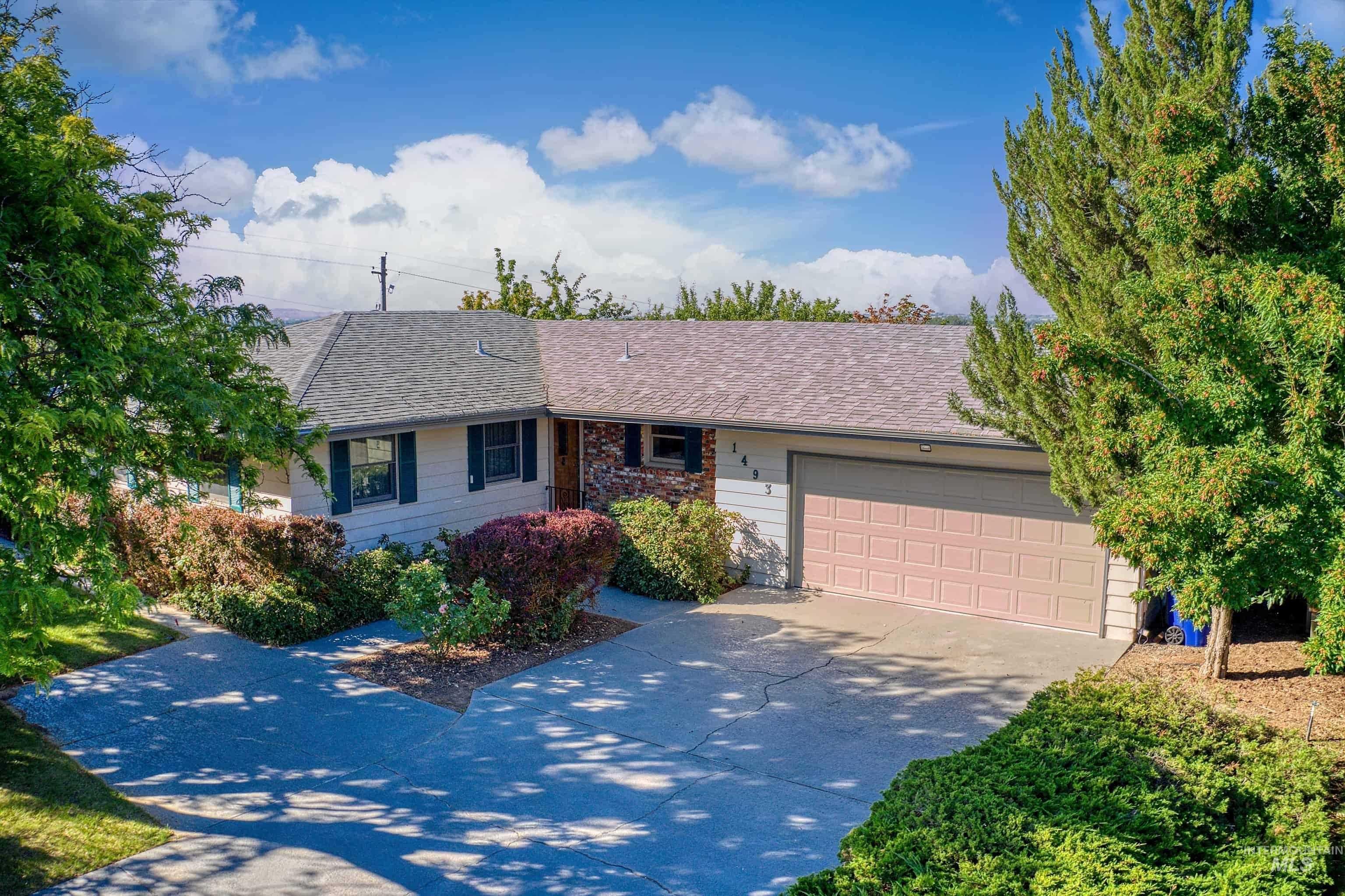 1493 Cove Road Weiser, ID 83672 - Photo 1 of 50 Ranch-style residence featuring a two-car garage, partial stone facade, and mature landscaping
