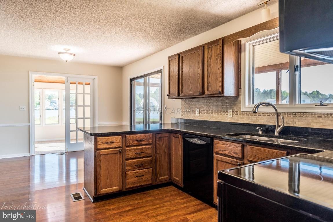 36 Saltgrass Road Ocean Pines, MD 21811 - Photo 23 of 70 a kitchen with stainless steel appliances granite countertop a stove a sink and a microwave