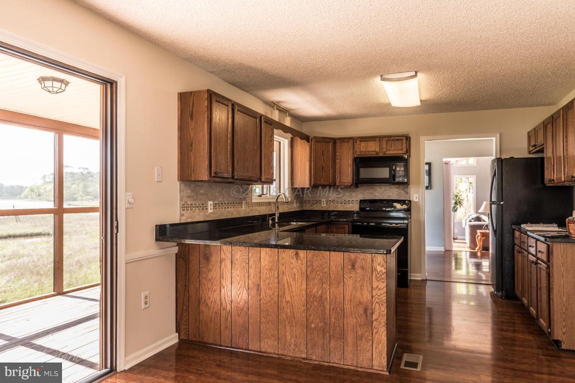 36 Saltgrass Road Ocean Pines, MD 21811 - Photo 24 of 70 a kitchen with stainless steel appliances granite countertop a stove a sink and a refrigerator