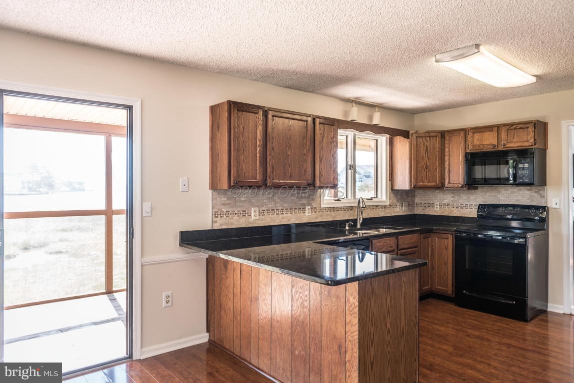 36 Saltgrass Road Ocean Pines, MD 21811 - Photo 25 of 70 a kitchen with granite countertop a sink and steel appliances