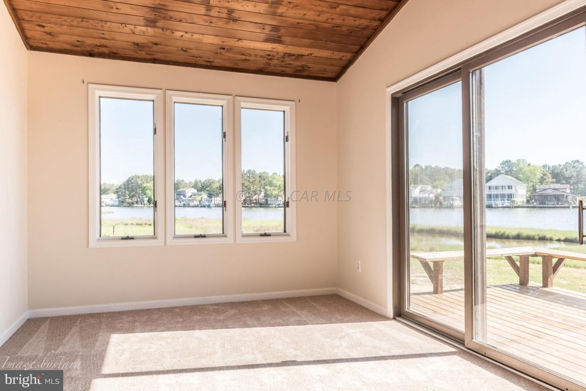 36 Saltgrass Road Ocean Pines, MD 21811 - Photo 26 of 70 a view of an empty room with wooden floor and a window