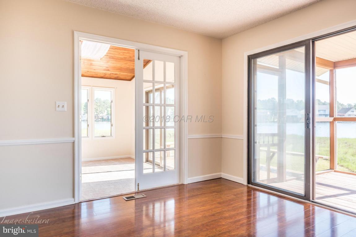 36 Saltgrass Road Ocean Pines, MD 21811 - Photo 28 of 70 a view of an empty room with wooden floor and a window