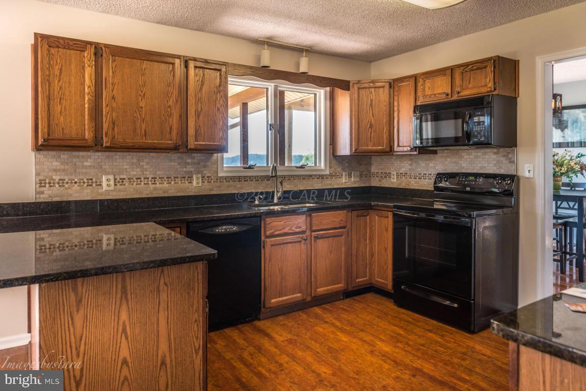 36 Saltgrass Road Ocean Pines, MD 21811 - Photo 31 of 70 a kitchen with a sink stove and microwave