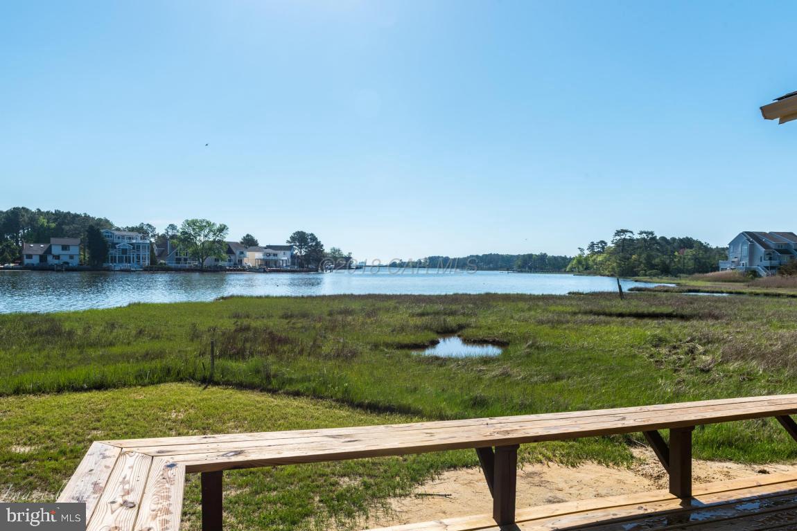 36 Saltgrass Road Ocean Pines, MD 21811 - Photo 34 of 70 a view of a lake with a yard and large trees