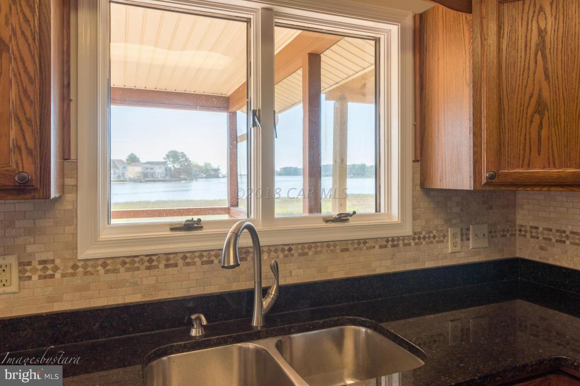 36 Saltgrass Road Ocean Pines, MD 21811 - Photo 39 of 70 a bathroom with a granite countertop sink and a bathtub next to a window