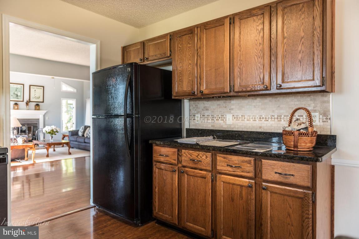 36 Saltgrass Road Ocean Pines, MD 21811 - Photo 40 of 70 a kitchen with stainless steel appliances granite countertop a refrigerator and a sink