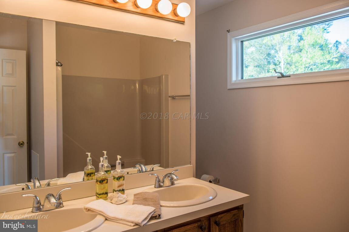 36 Saltgrass Road Ocean Pines, MD 21811 - Photo 51 of 70 a bathroom with a sink and a mirror