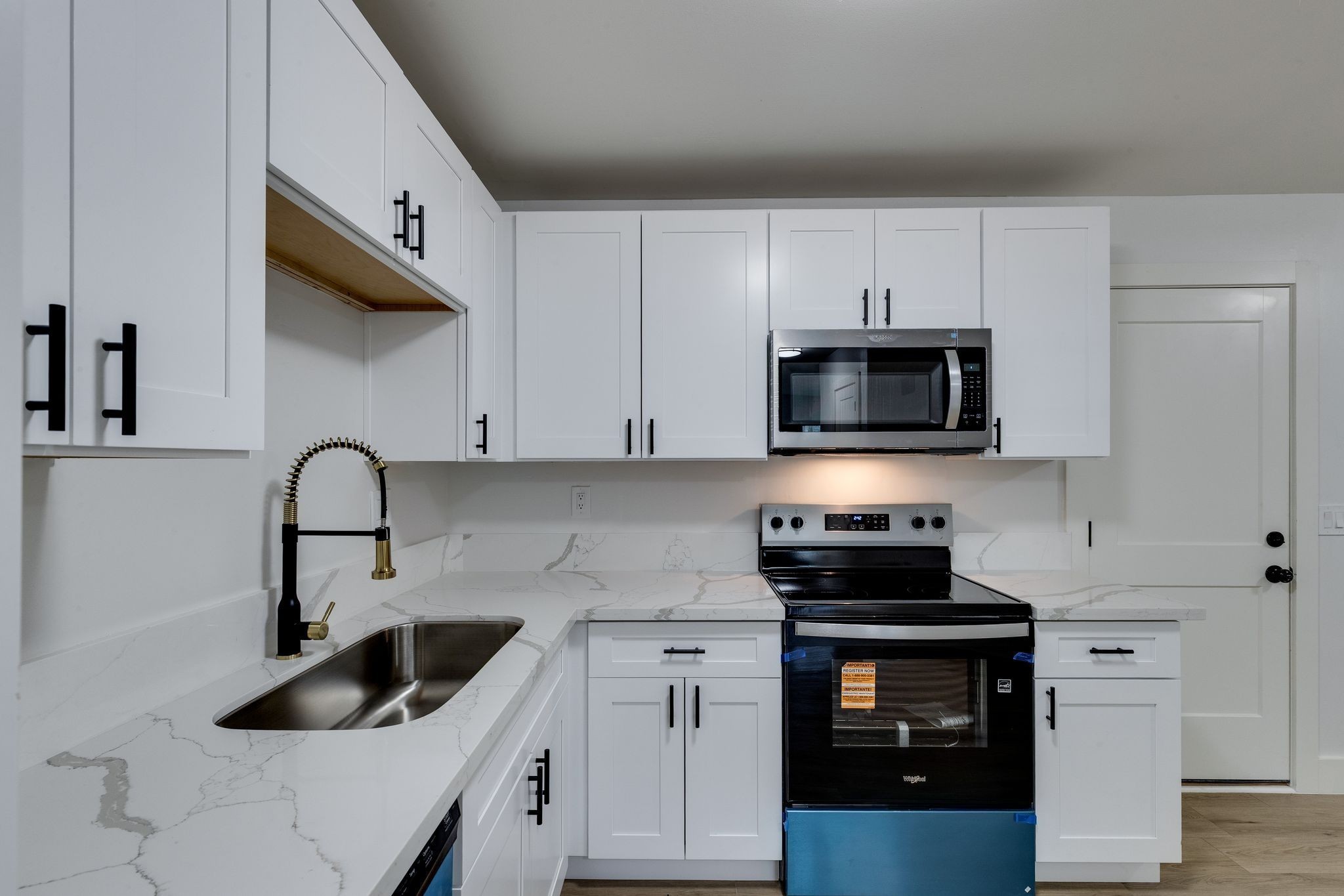 634 North 5th Street Nashville, TN 37207 - Photo 10 of 27 a kitchen with white cabinets a sink and a stove