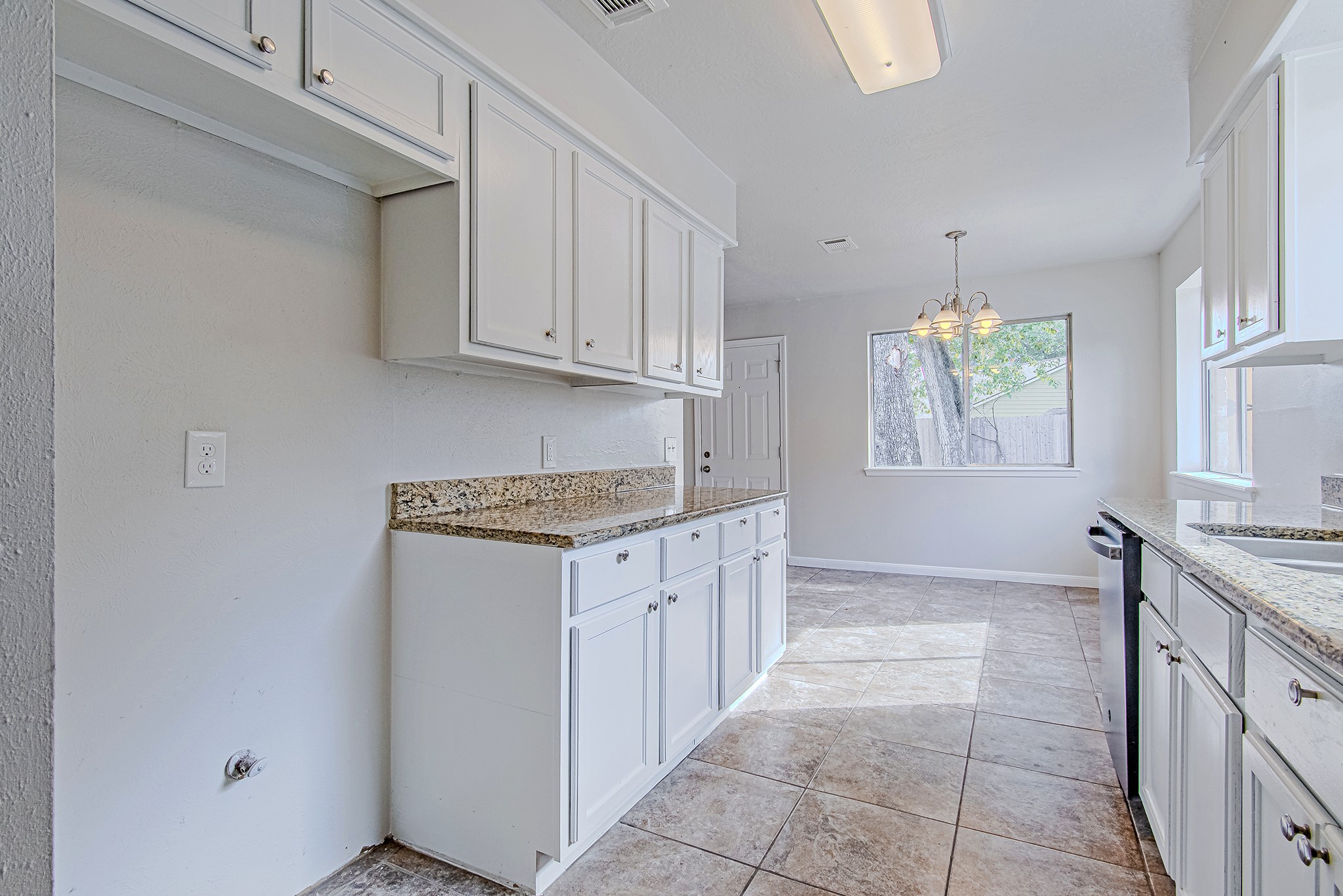 24306 Spring Mill Lane Spring, TX 77373 - Photo 12 of 24 a kitchen with granite countertop a sink stove and cabinets