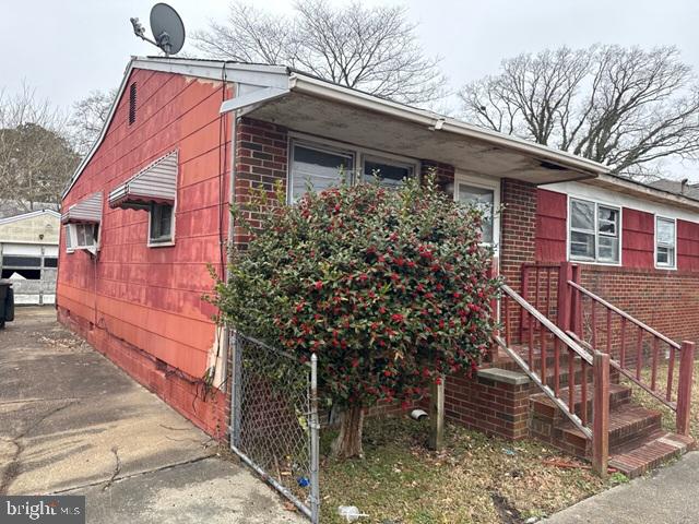 2441 Alder Street Norfolk, VA 23513 - Photo 2 of 11 a front view of a house with a yard