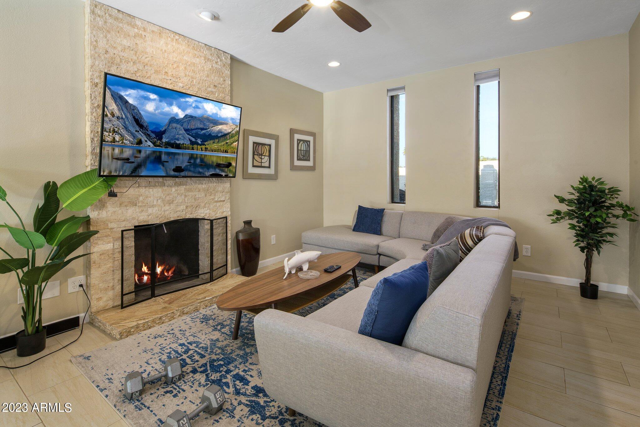 6609 East Phelps Road Scottsdale, AZ 85254 - Photo 3 of 83 a living room with furniture and a fireplace