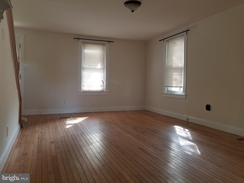 949 Fairview Avenue Wayne, PA 19087 - Photo 3 of 11 an empty room with wooden floor and windows