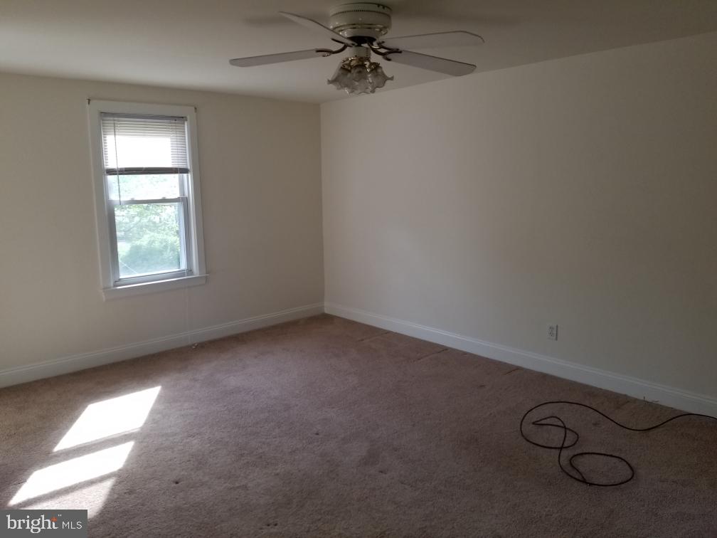 949 Fairview Avenue Wayne, PA 19087 - Photo 6 of 11 an empty room with windows and fan