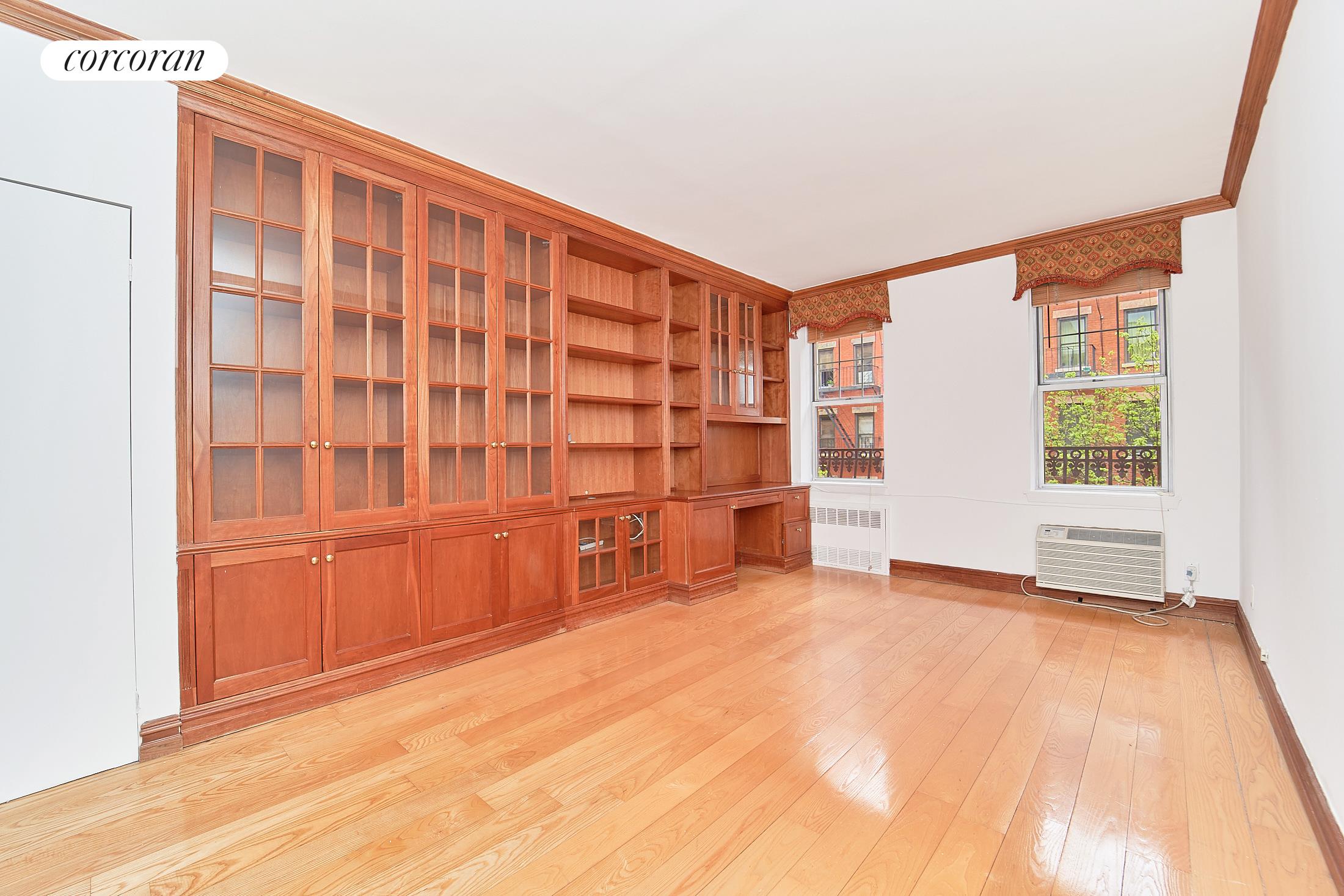 319 East 73rd Street, Unit 4B Manhattan, NY 10021 - Photo 1 of 1 an empty room with cabinet and mirrors