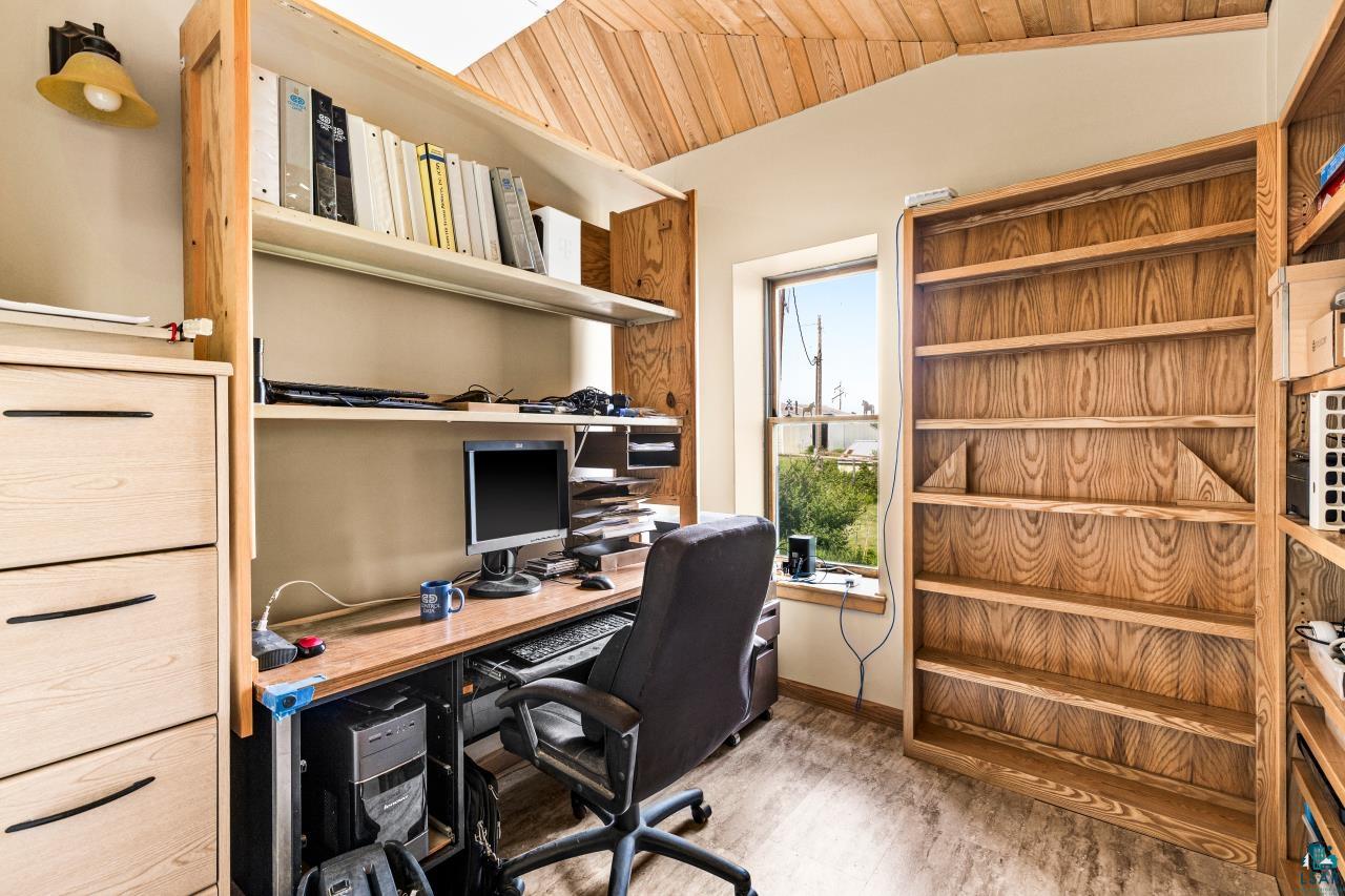 4800 Tower Road Moose Lake, MN 55767 - Photo 22 of 83 Dedicated space featuring built-in shelving, a large window, wood-finish flooring, and a natural wood ceiling