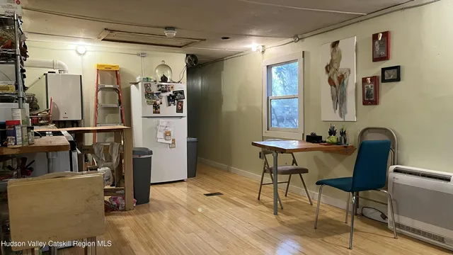 a view of a workspace with furniture and a window