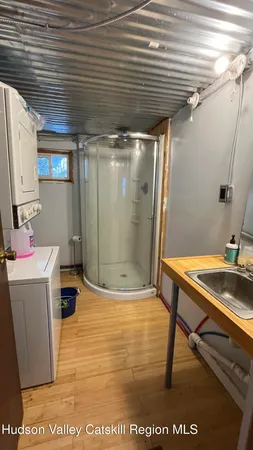 a room with water heater and wooden cabinets