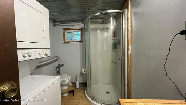 a bathroom with a toilet and a shower