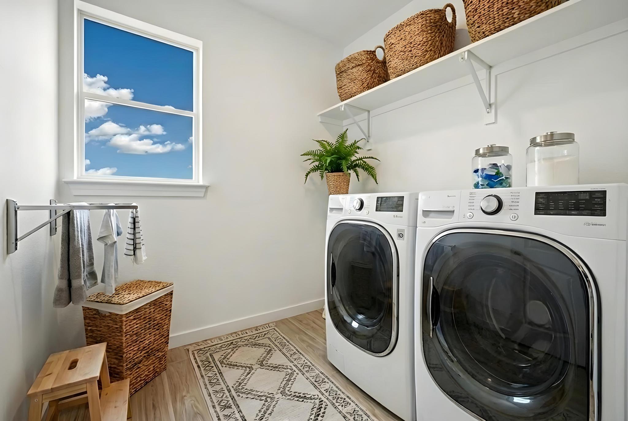 13501 Sierra Wind Lane Elgin, TX 78621 - Photo 5 of 19 Dedicated laundry room featuring front-loading appliances, white cabinetry, wood-finish flooring, and a window for natural light