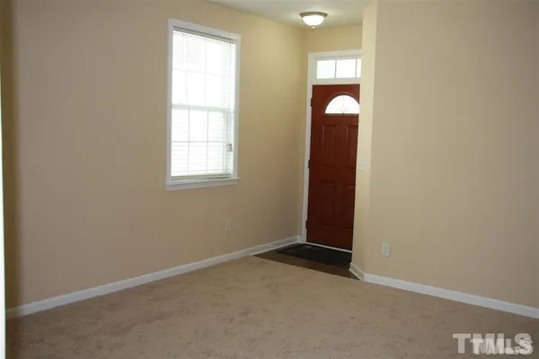 an empty room with closet and windows