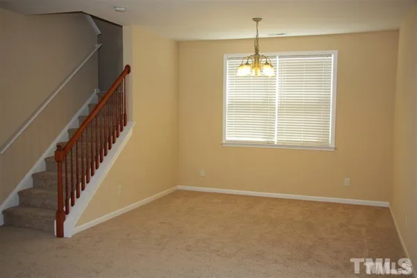 a view of an empty room with stairs