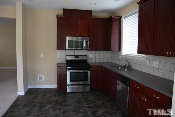 a kitchen with a sink stove and microwave