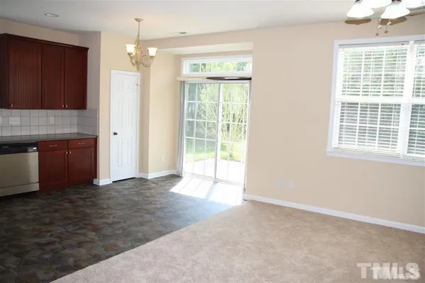 a view of a kitchen with wooden floor and a kitchen