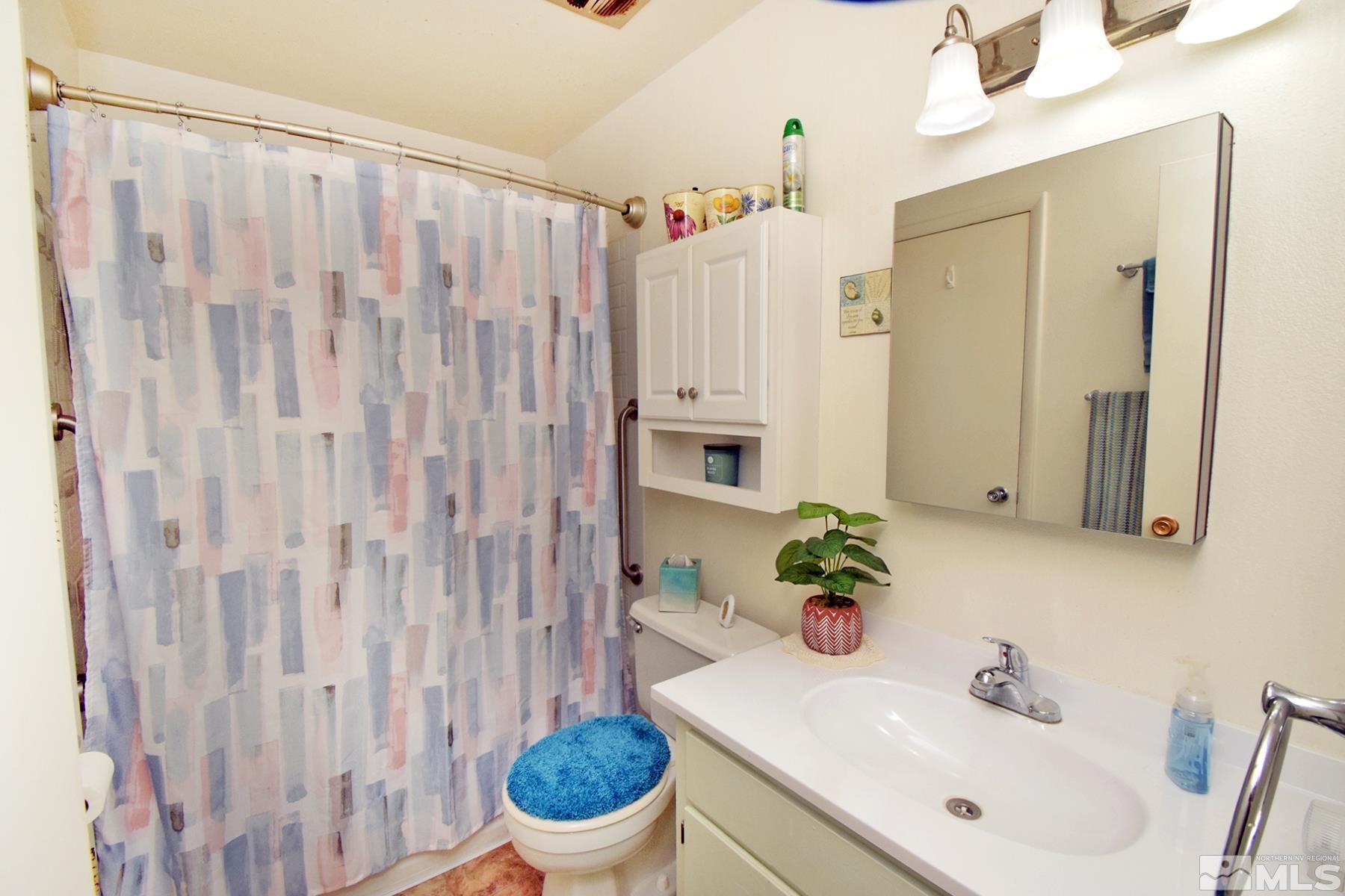 1848 Matteoni Drive Sparks, NV 89434 - Photo 12 of 34 a bathroom with a sink a toilet and a mirror