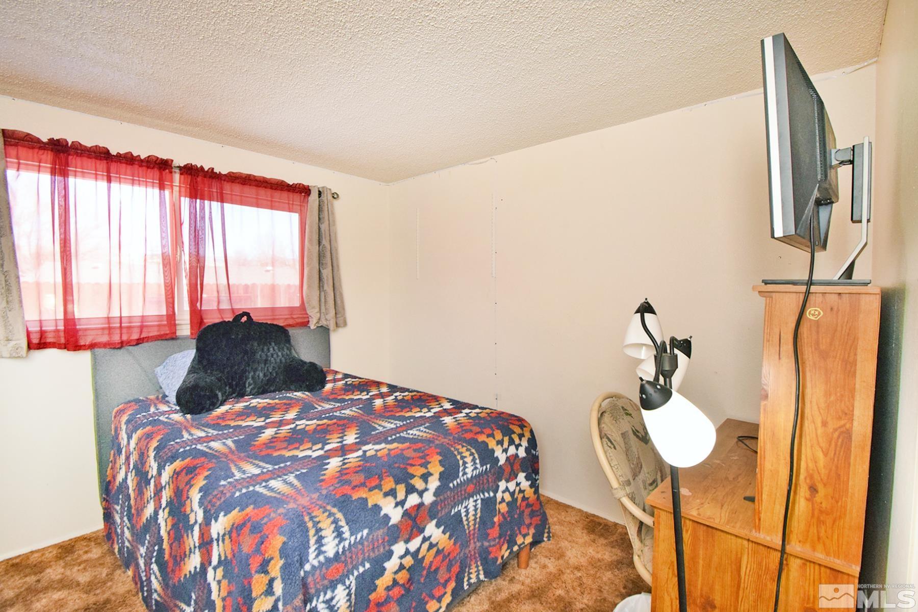 1848 Matteoni Drive Sparks, NV 89434 - Photo 13 of 34 a bedroom with a bed and wooden floor