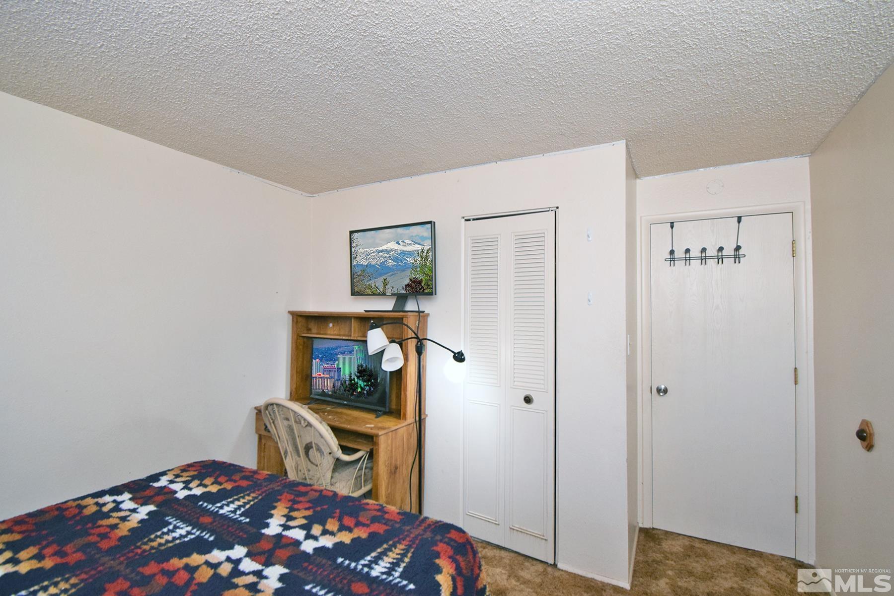 1848 Matteoni Drive Sparks, NV 89434 - Photo 14 of 34 a bedroom with a bed and a chandelier