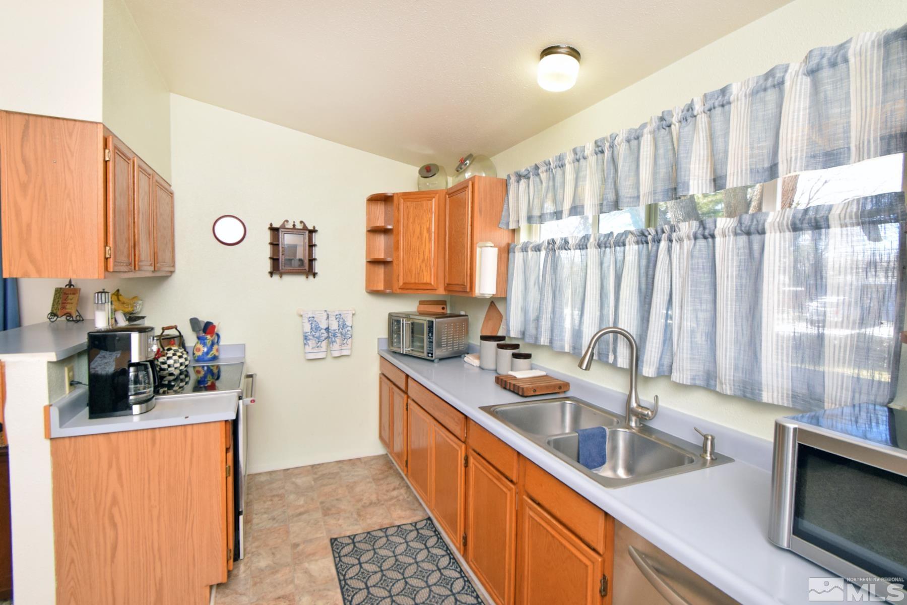 1848 Matteoni Drive Sparks, NV 89434 - Photo 16 of 34 a kitchen with stainless steel appliances a sink a stove and a refrigerator