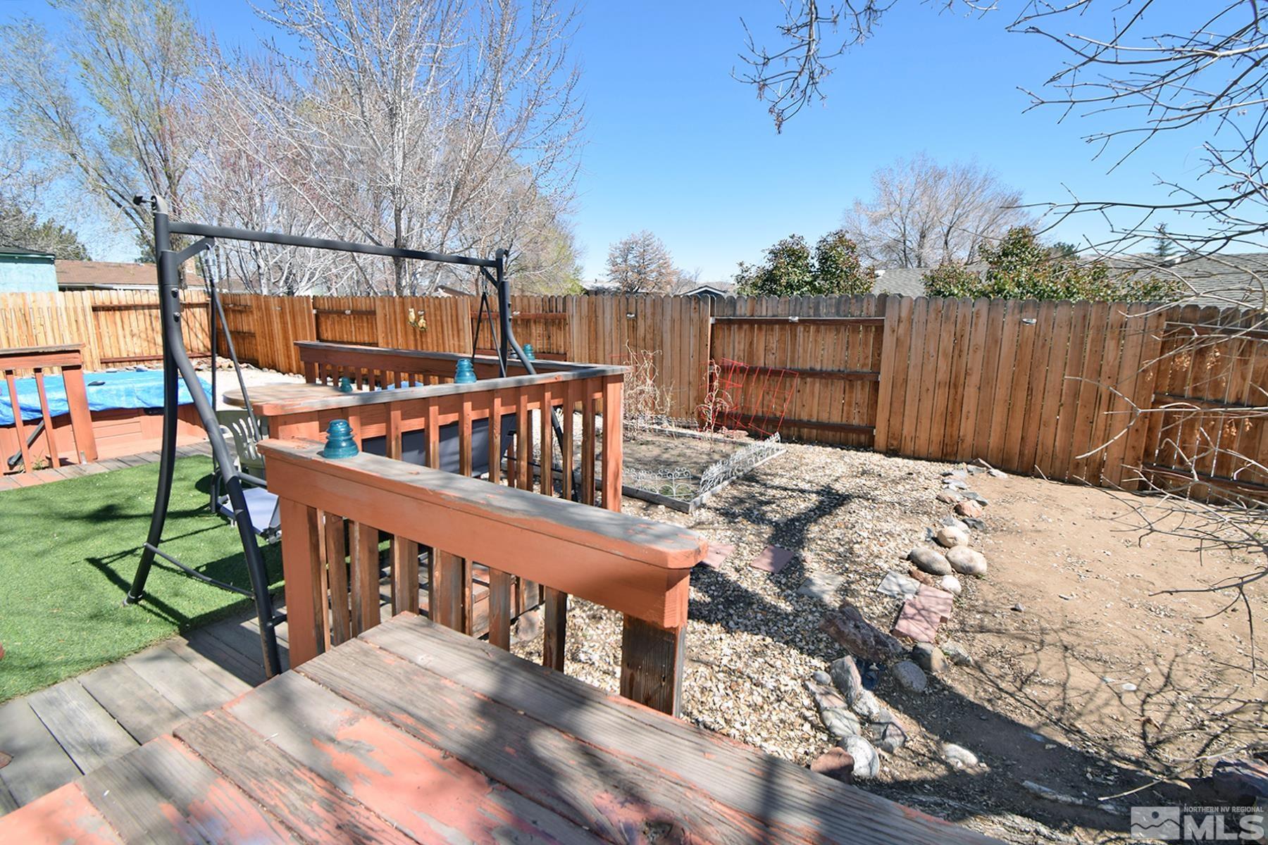 1848 Matteoni Drive Sparks, NV 89434 - Photo 20 of 34 a view of a wooden deck with chairs and wooden fence