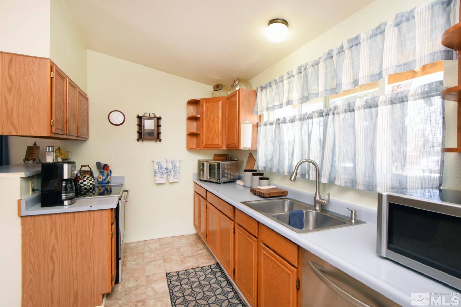 1848 Matteoni Drive Sparks, NV 89434 - Photo 3 of 34 a kitchen with stainless steel appliances a sink a stove and a refrigerator