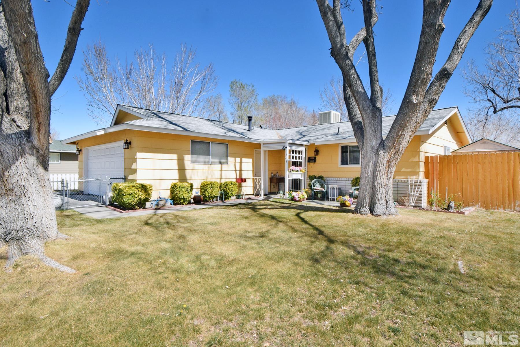 1848 Matteoni Drive Sparks, NV 89434 - Photo 31 of 34 a view of a house with a large tree and wooden fence