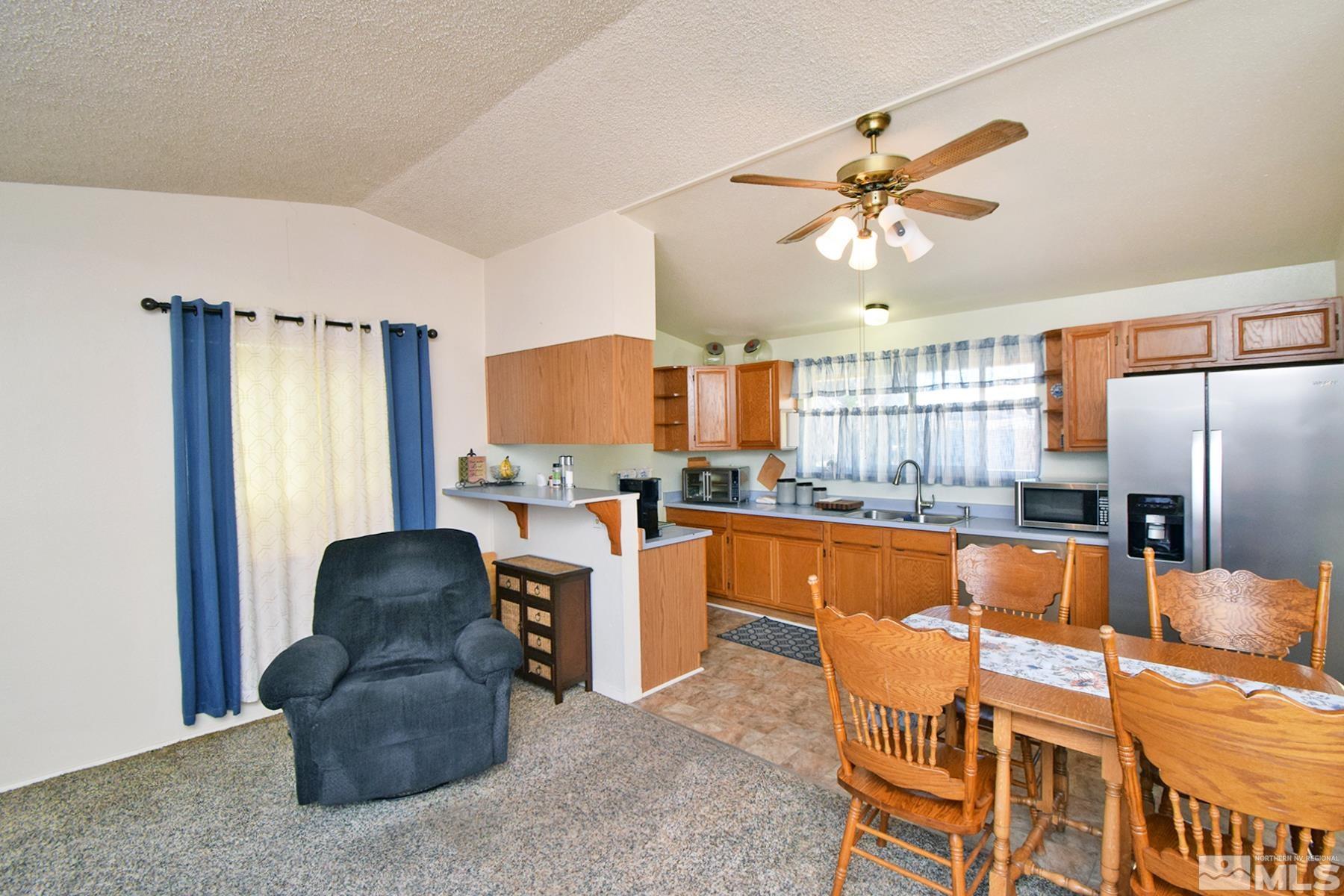 1848 Matteoni Drive Sparks, NV 89434 - Photo 5 of 34 a kitchen with stainless steel appliances granite countertop a refrigerator a stove and a sink with granite countertops
