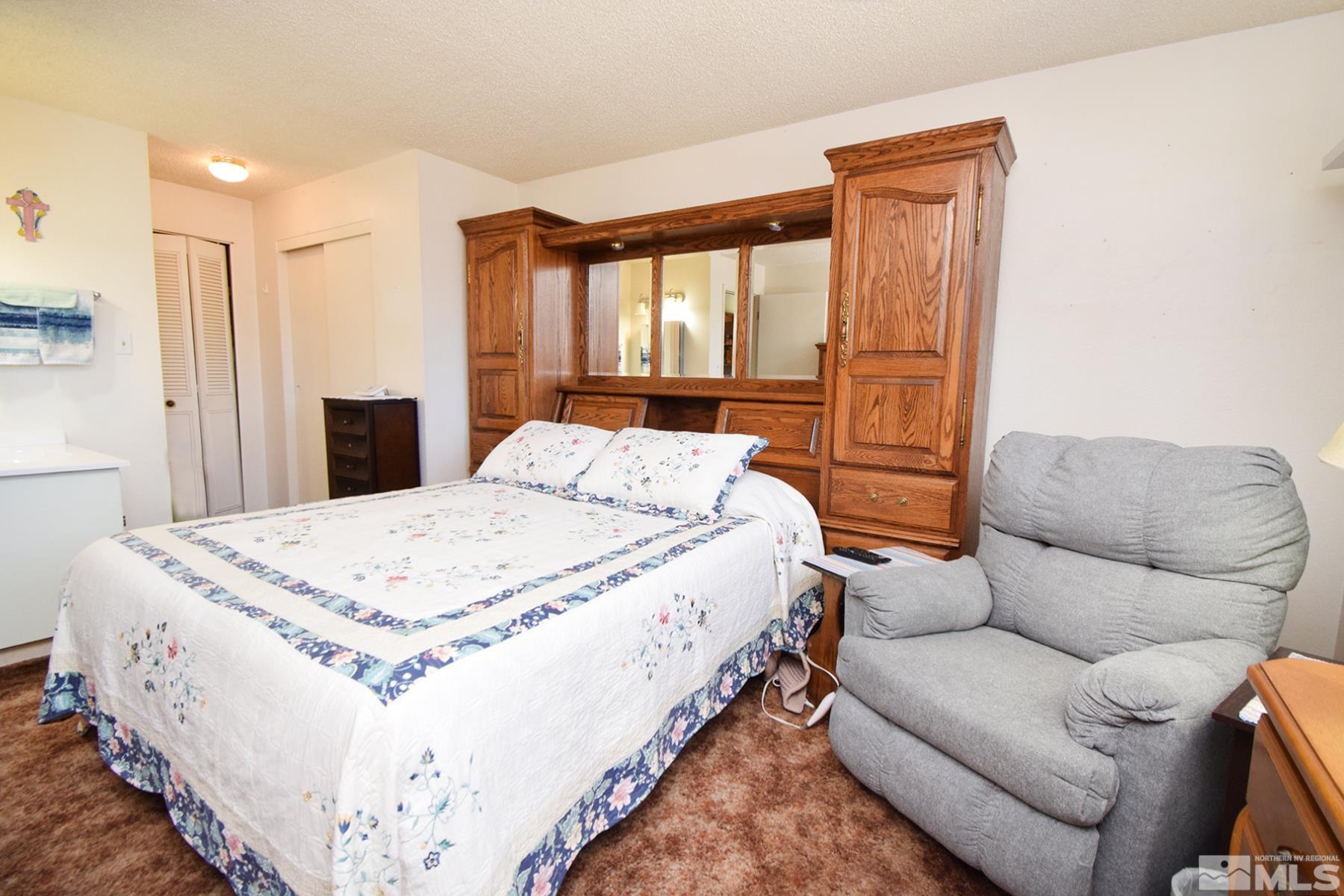 1848 Matteoni Drive Sparks, NV 89434 - Photo 8 of 34 a spacious bedroom with a bed and a couch