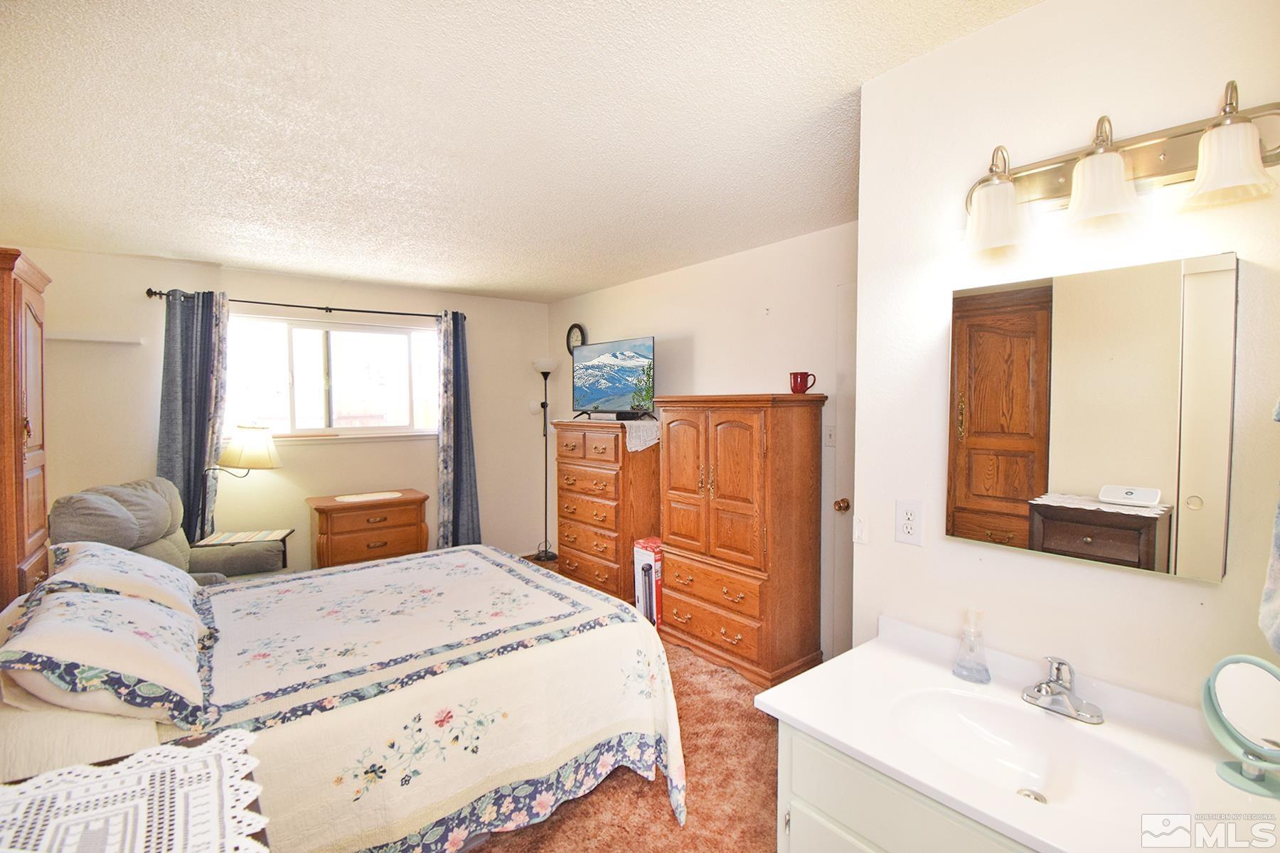 1848 Matteoni Drive Sparks, NV 89434 - Photo 9 of 34 a bedroom with a bed and wooden floor