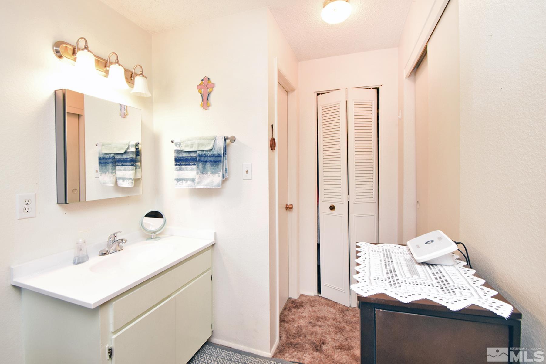 1848 Matteoni Drive Sparks, NV 89434 - Photo 10 of 34 a bathroom with a sink vanity and mirror