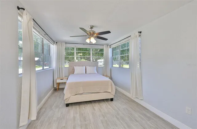 a bedroom with a large bed and a large window