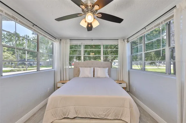 a bedroom with a large bed window and closet