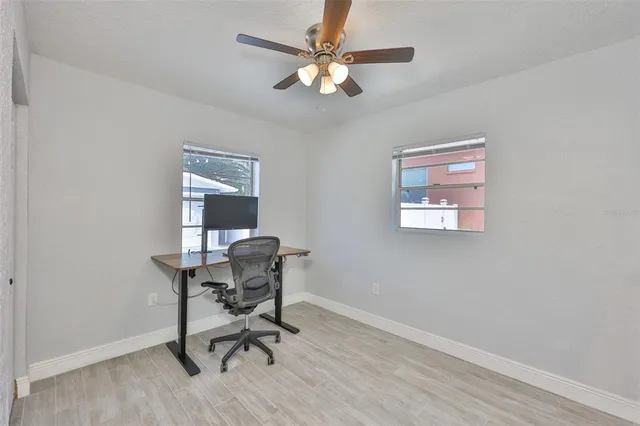 a workspace with wooden floor and a window
